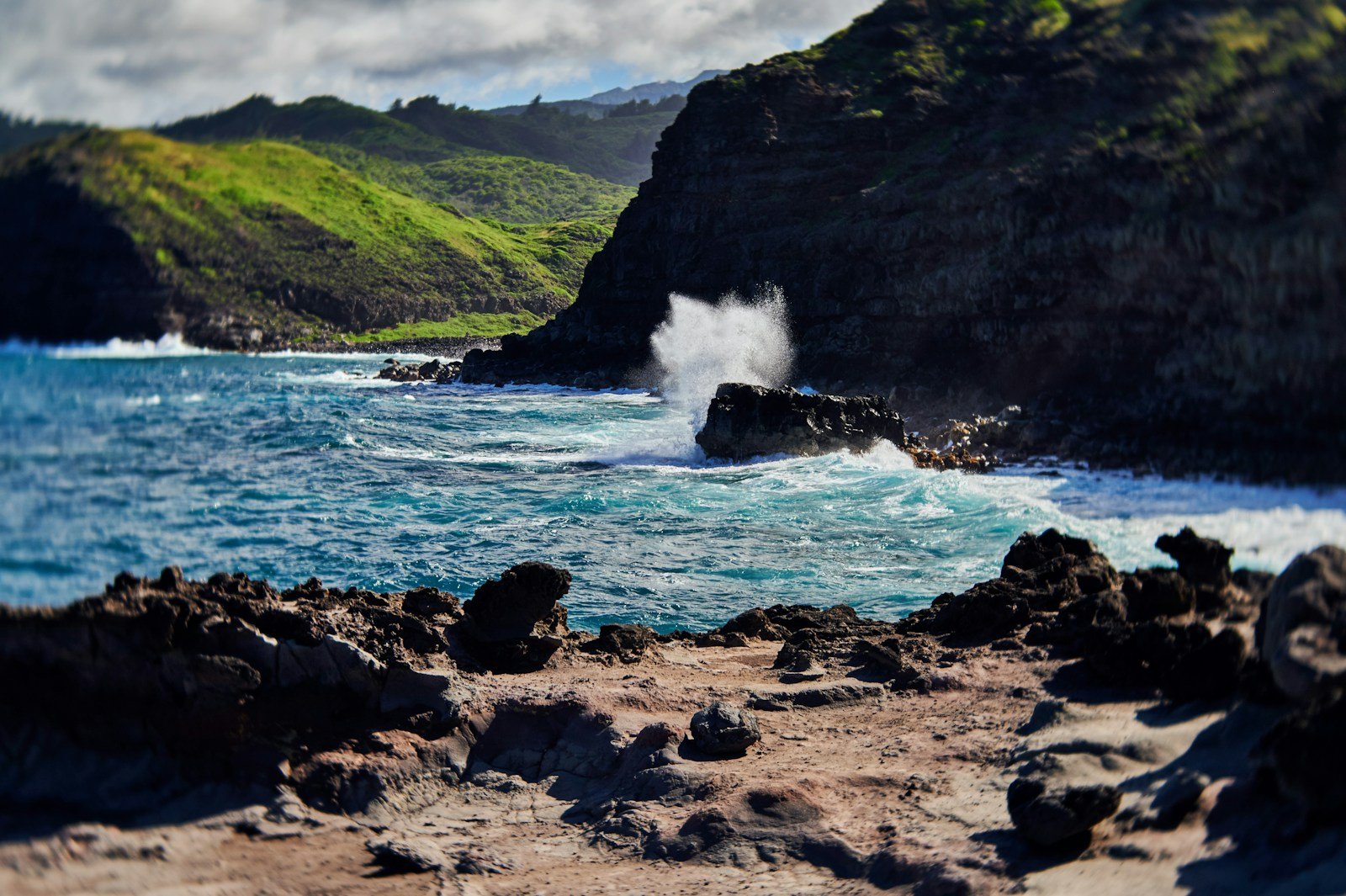 a large wave crashing into the shore of a beach